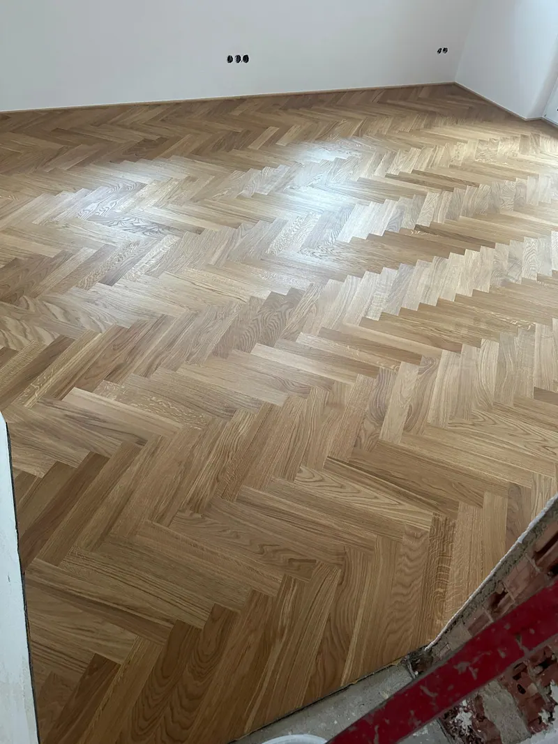 Detailansicht eines präzise verlegten Fischgrätparketts